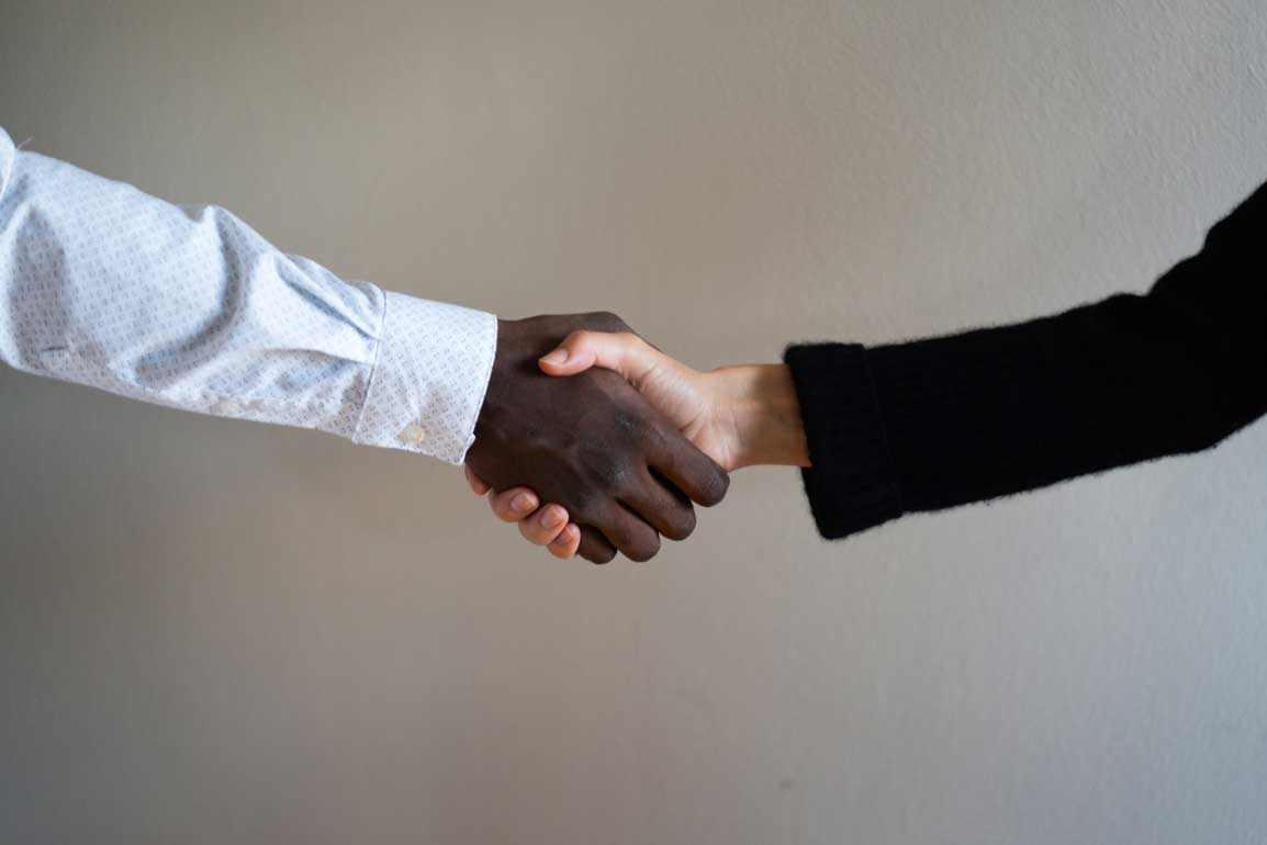Two business professionals greeting one another